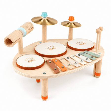 A wooden toy drum set with cymbals, drum pads, a xylophone, and mallets on a white background.