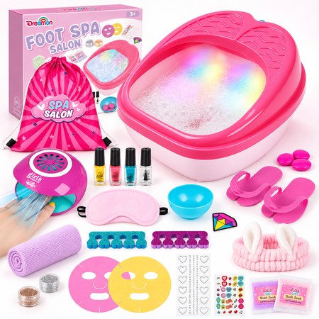 A children's foot spa set displayed on a white background, including a pink foot basin with iridescent bubbly water, a pink drawstring bag, nail polish bottles, a handheld fan, a towel, face masks, stickers, and other spa accessories. The box reads 'Dreamin FOOT SPA SALON'.