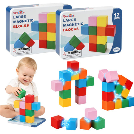 Dreamon large magnetic blocks set shown with two product boxes, loose colorful blocks, and a baby playing with the blocks. The boxes read 'Dreamon LARGE MAGNETIC BLOCKS' and '12 PCS'.