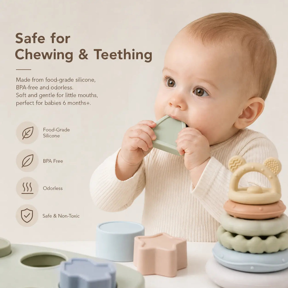 Baby chewing a silicone sensory toy set with textured balls, stacking rings, and shape pieces