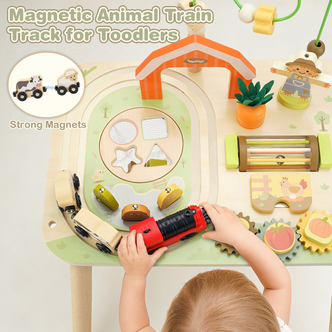 Toddler exploring a wooden farm activity table with moving pieces
