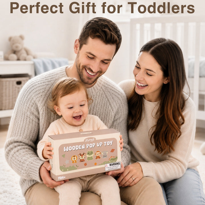 A smiling toddler sits on a man&